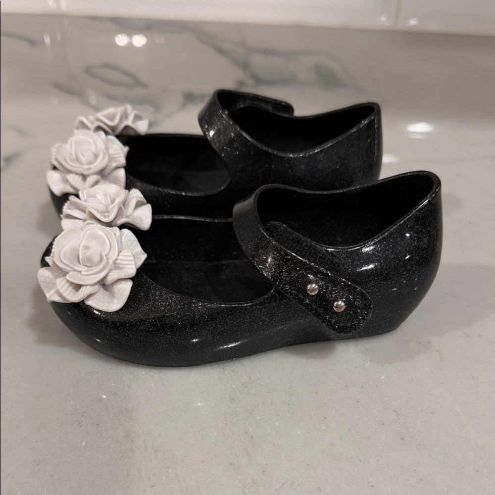 Mini Melissa Sparkly Black Shoes with White Rose Details